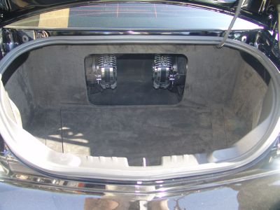 Two TREO SSp Subwoofers in suede-lined trunk with amp covers in place