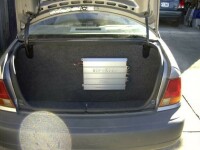 HiFonics Four-Channel Amplifier in Jeff's trunk with custom trim panels