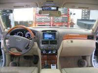 OEM Lexus navigation retained with custom mounted Clarion Pro Audio CD player and Sirius satellite radio and custom fiberglass kick panels