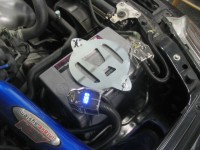 Honda logo battery hold-down with SVR battery and Stinger voltage display terminal and AEM intake